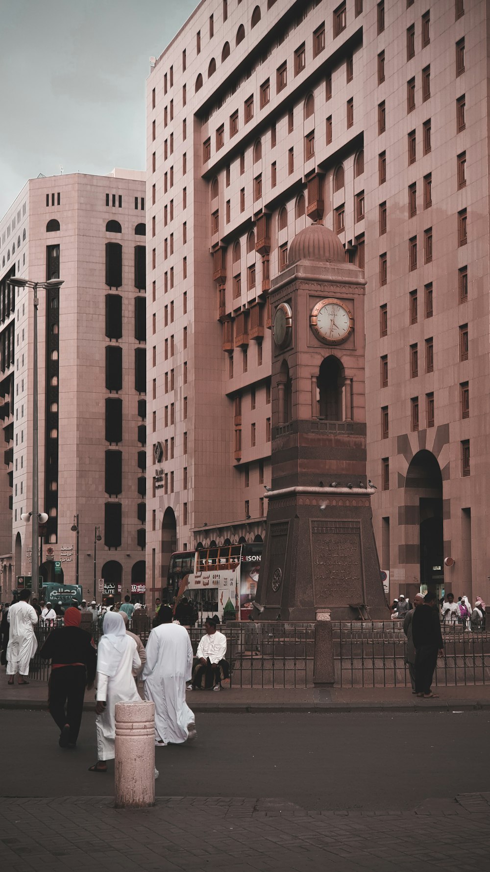 people walking beside brown concrete buildings