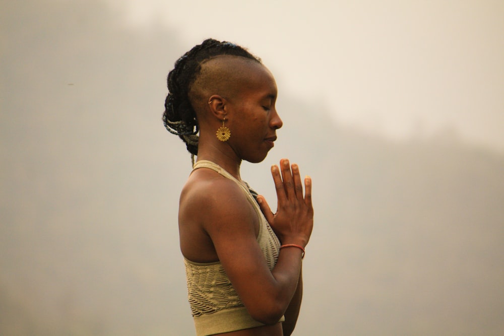 woman wearing brown crop top while praying