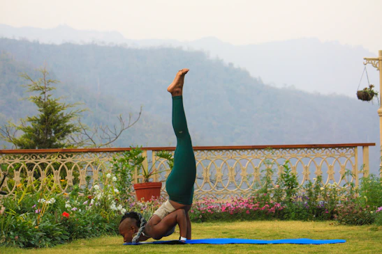 A serene tropical garden with people practicing yoga on stone pathways surrounded by lush greenery.