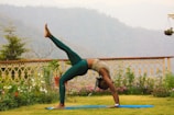 woman in teal leggings posing yoga