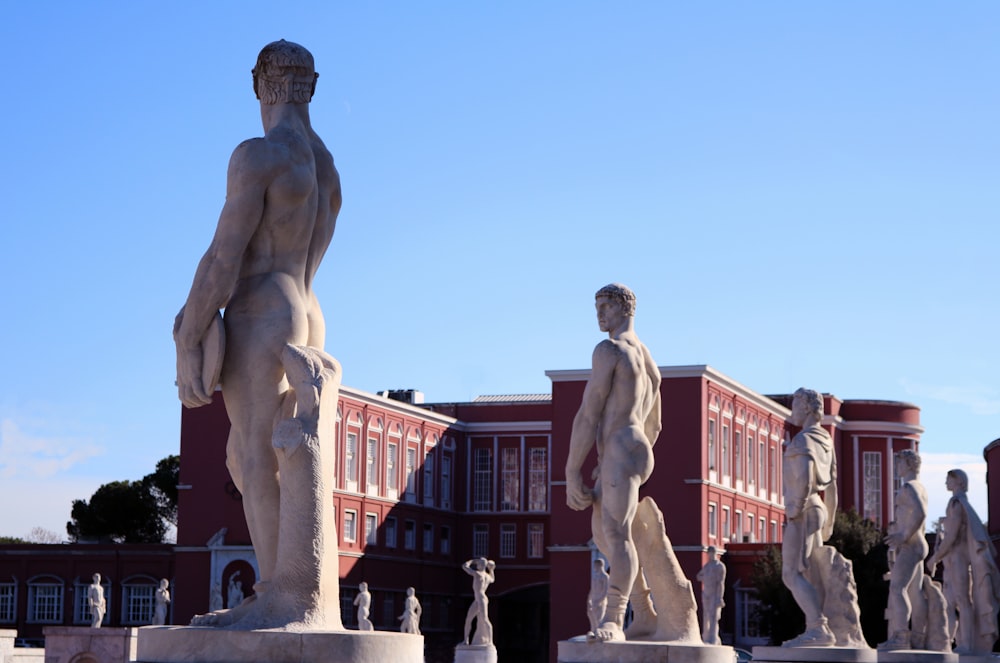 statue of people near brown building during daytime