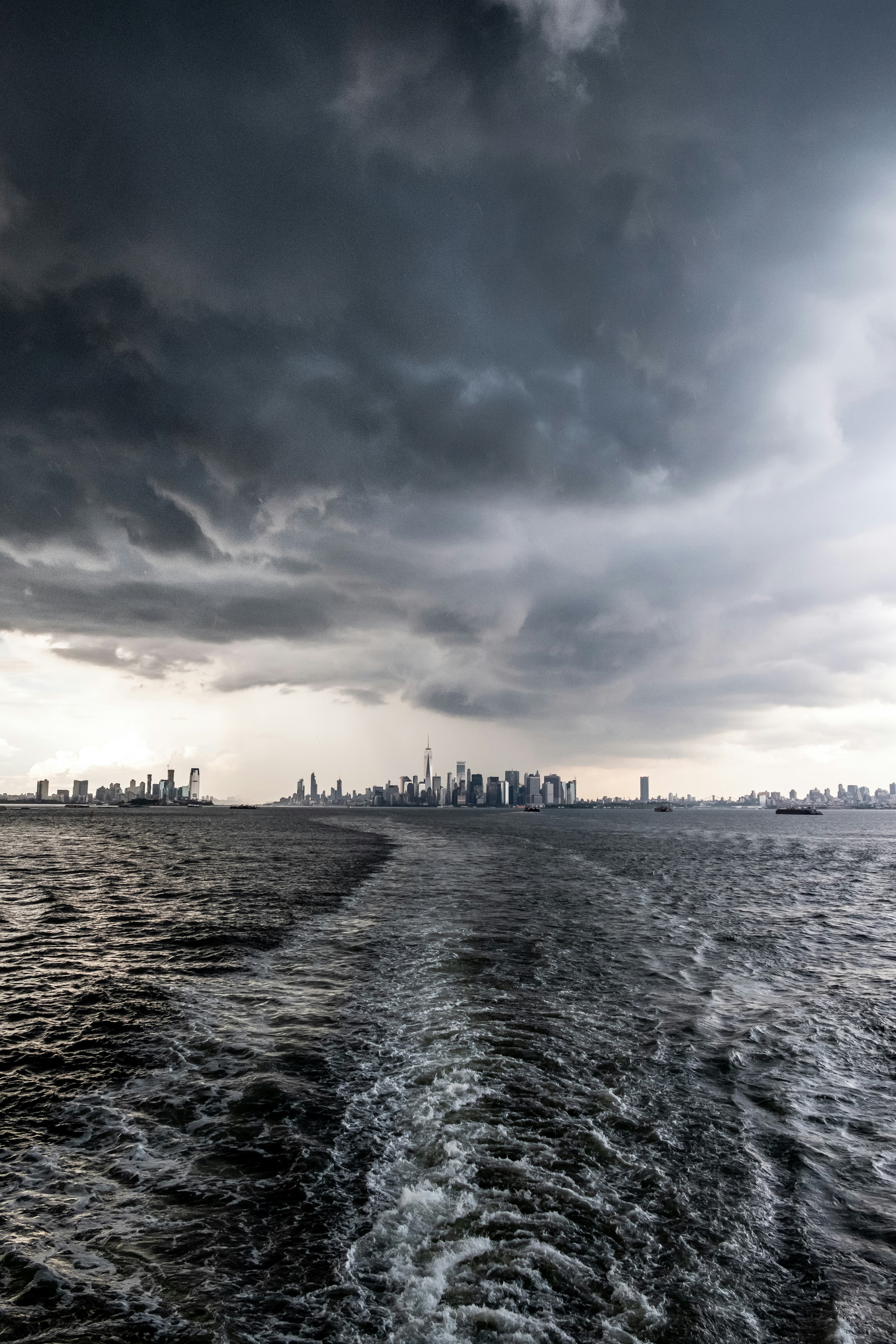 body of water under gray clouds