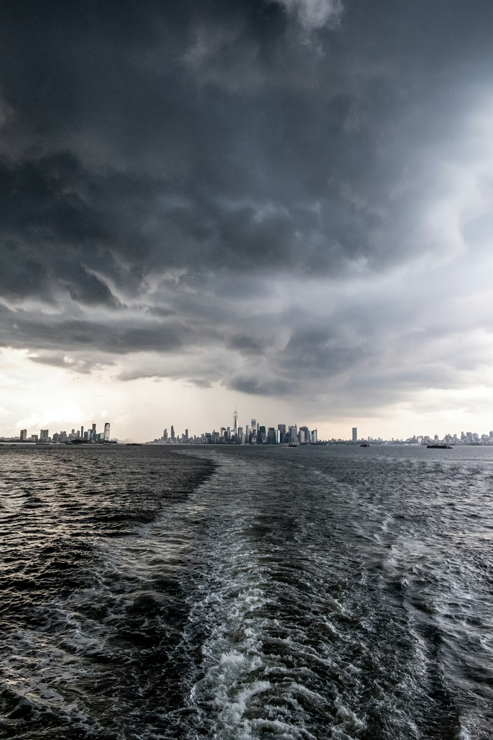 body of water under gray clouds