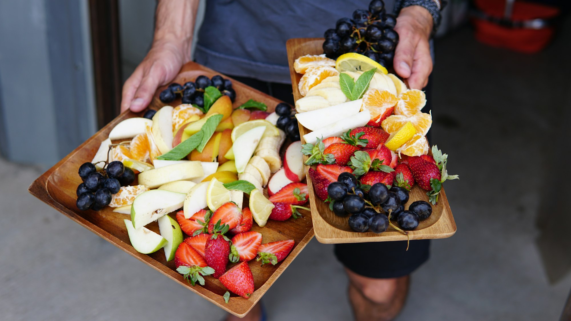 Two fresh fruit platters at summer party