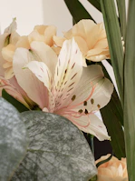 Elegant white lilies and soft pink carnations artfully arranged for a special occasion.