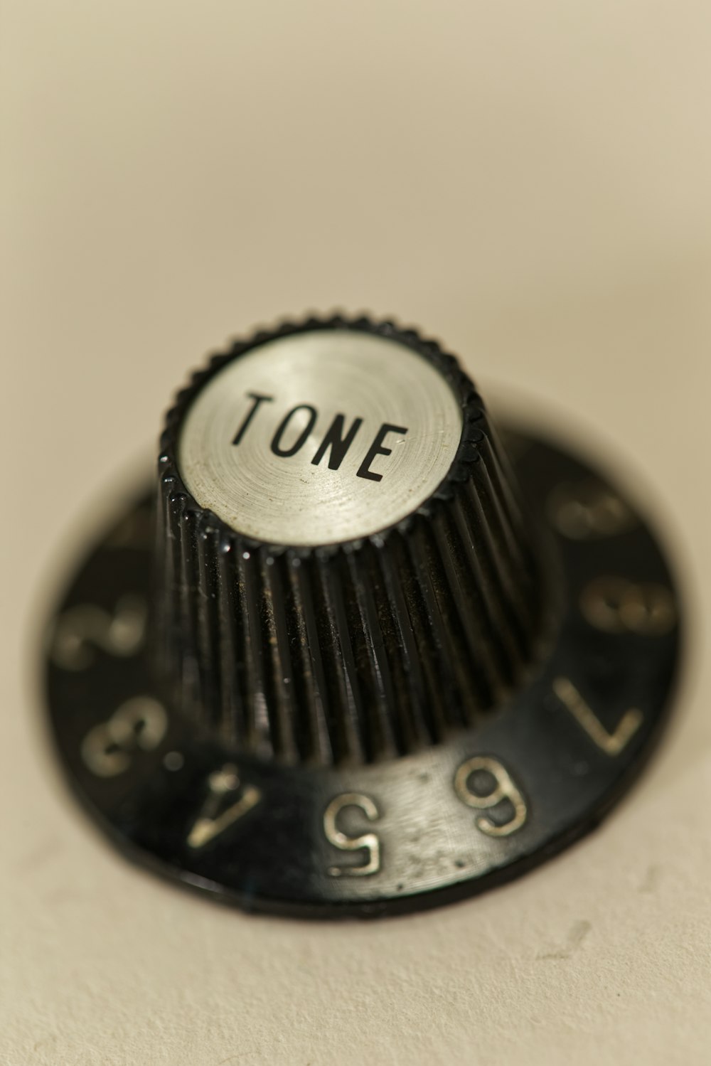 Tone control knob on white surface