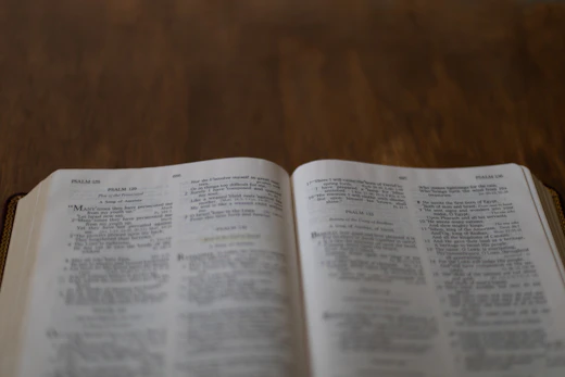 Open Bible detail on a wooden table