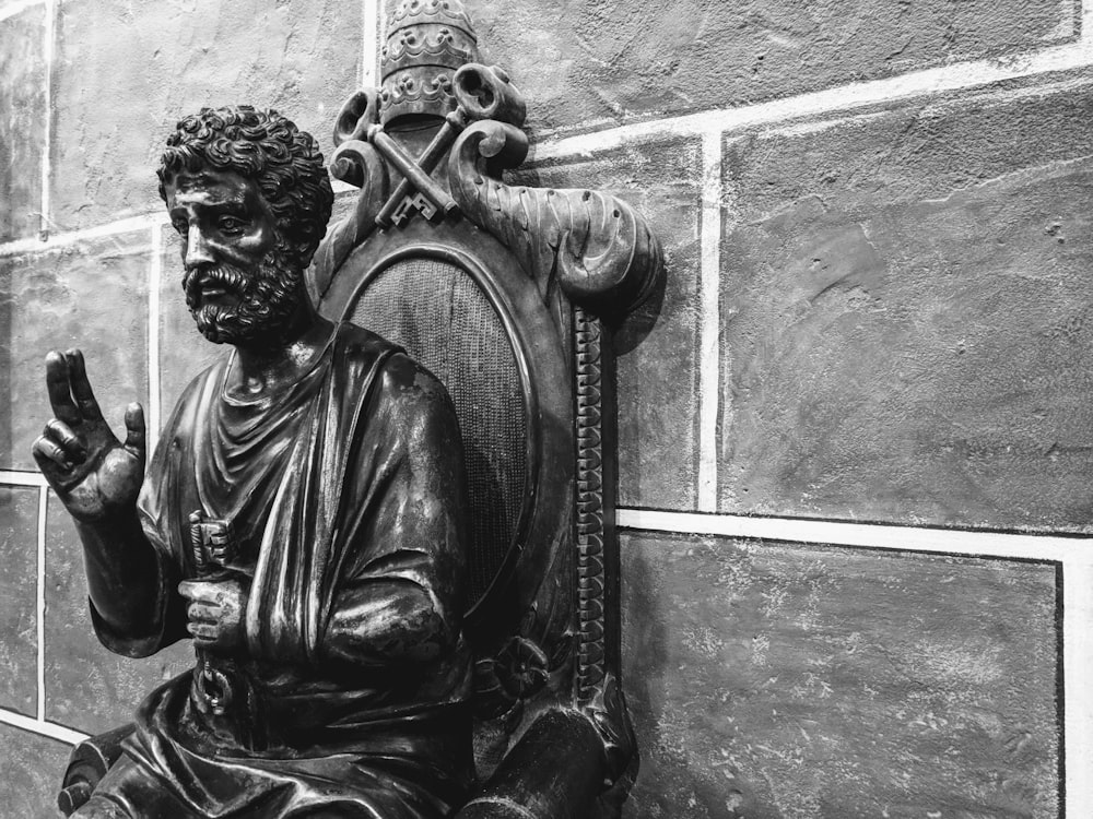 injured man sits on chair statue