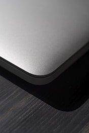 A close-up photo of the sleek gadget resting on a wooden desk with natural light.