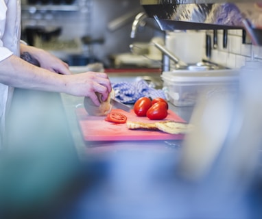 person slicing tomatoes