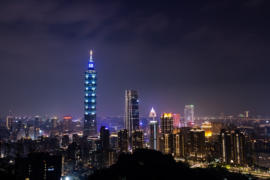 black and gray high buildings at nighttime