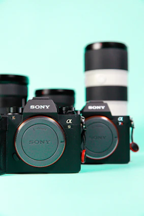 A sleek display of premium Canon and Sony cameras with gold accents on a black background