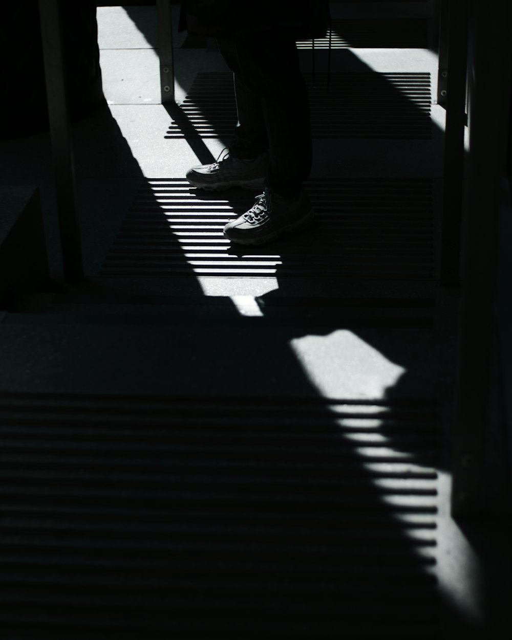 the shadow of a person sitting on a bench