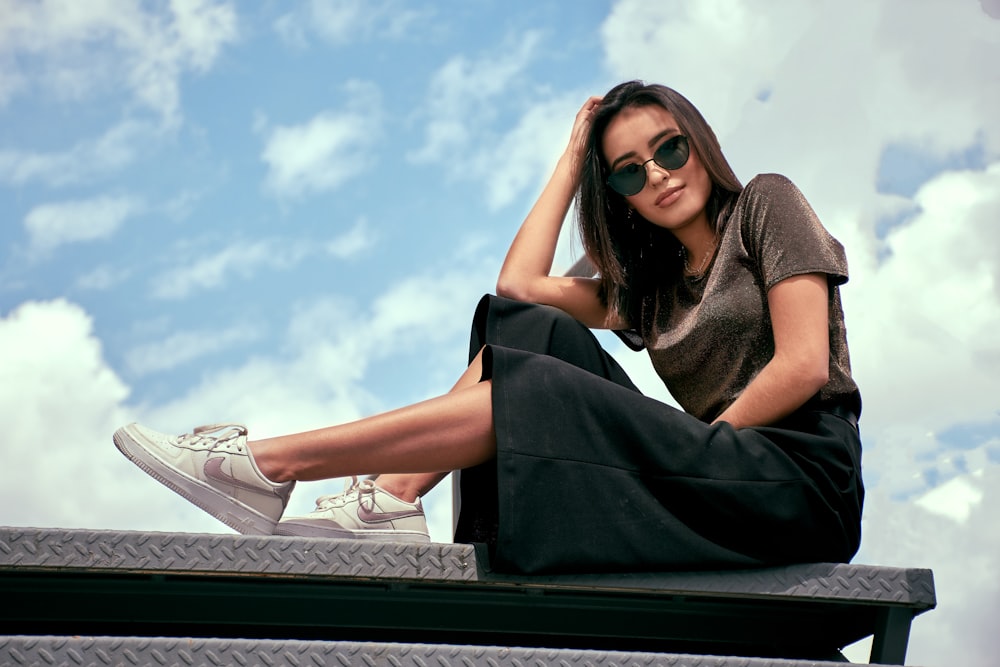 sitting girl holding her head during daytime