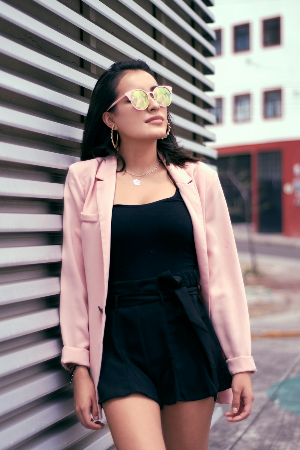 woman wearing pink cardigan and black romper