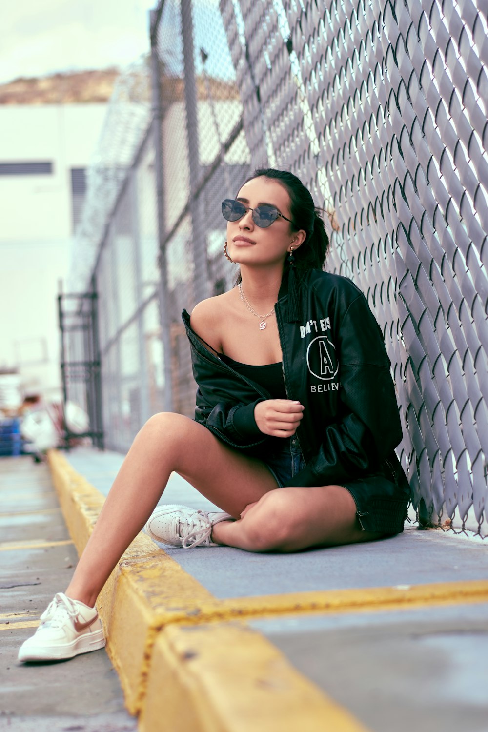 woman sitting on sidewalk