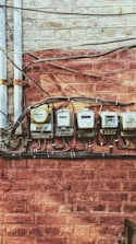 five electric meters on wall