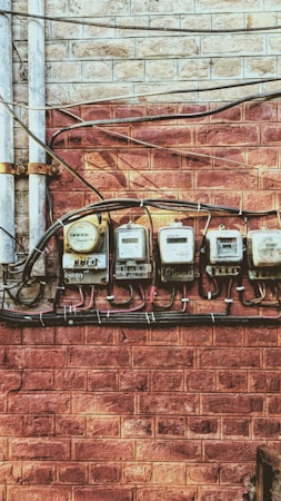 A row of electric meters on a wall, representing the city-owned utilities under the Boulder City rate proposal