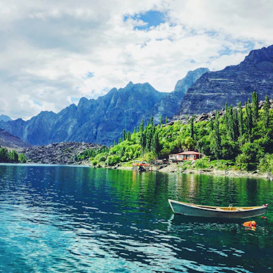 A peaceful boat ride on a crystal-clear lake surrounded by lush greenery.