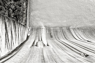 A detailed simulation of water flow through a dam spillway, showing velocity and pressure distribution.