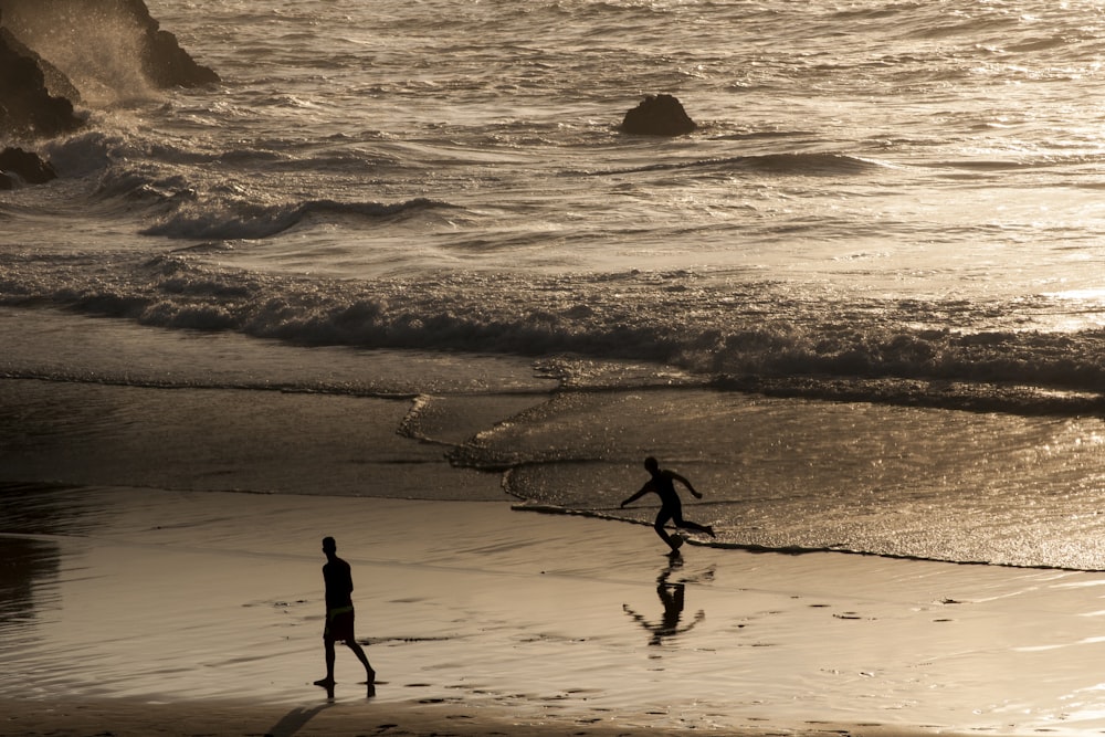 silhouette of two person on shore