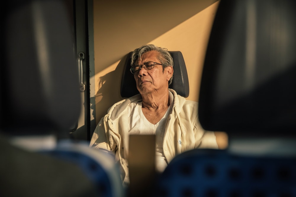 man sitting on leather vehicle seat