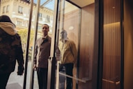 Chauffeur opening the door of a luxury vehicle for a well-dressed client.
