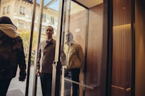An elegant concierge assisting a well-dressed client in a high-end hotel lobby.
