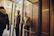 A smiling concierge warmly greeting a delighted couple at a luxury hotel entrance.