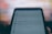 A close-up of a smartphone screen displaying a settings and privacy menu. The text appears slightly blurred, with options like settings, privacy shortcuts, and terms and policies visible. The background is out of focus, creating a contrast with the darker foreground.