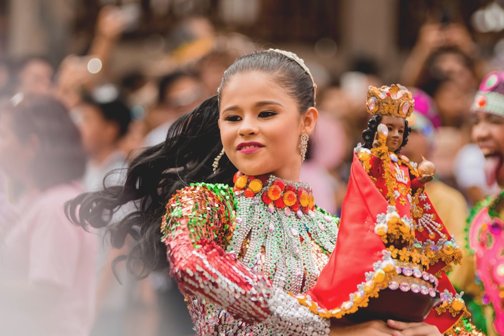 girl dancing while holding Sto.Nino figurine