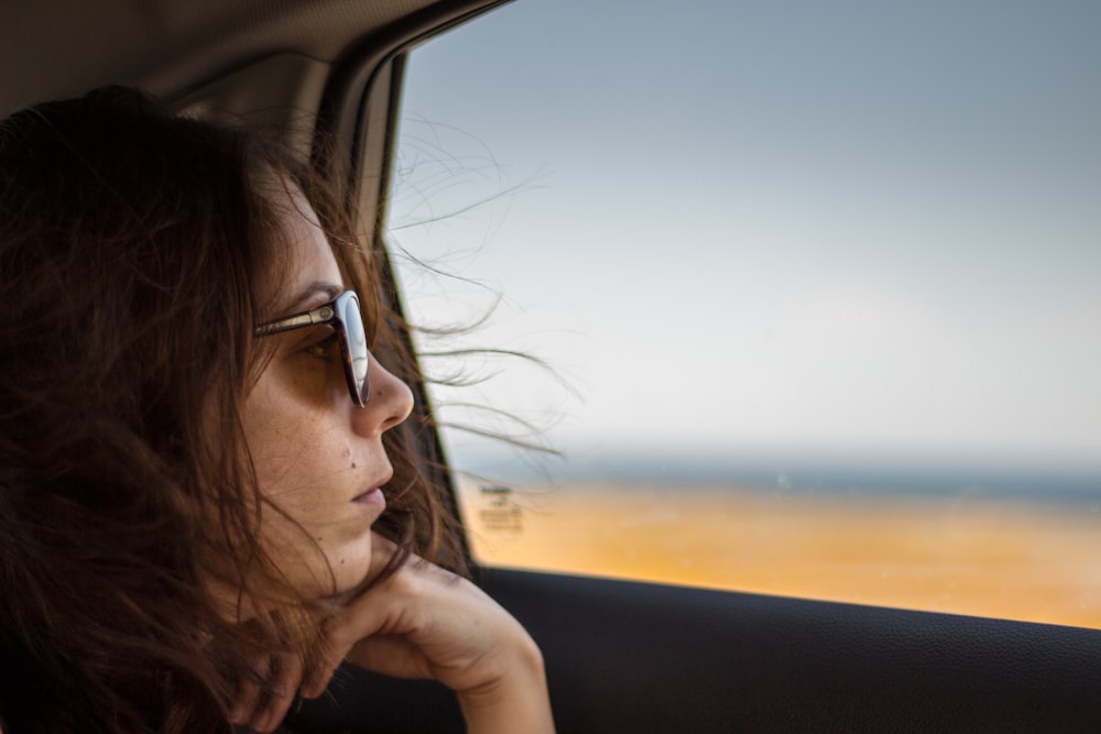 woman facing vehicle window