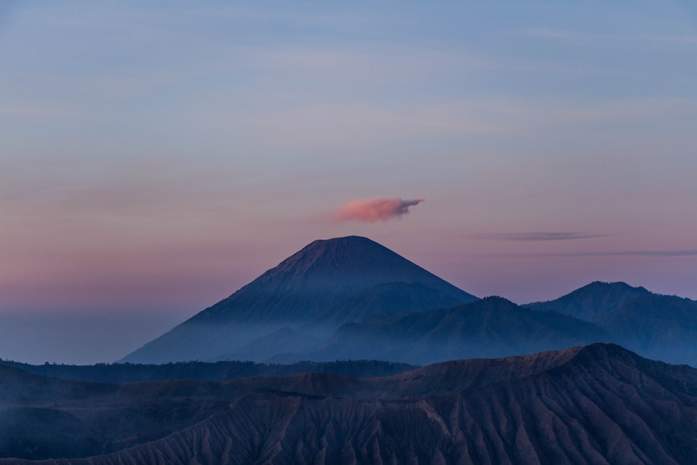 brown and white mountain under white clouds during daytime