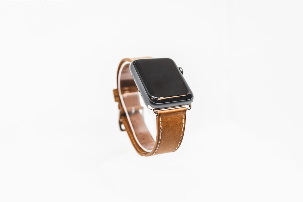 space gray aluminum case apple watch with brown leather strap