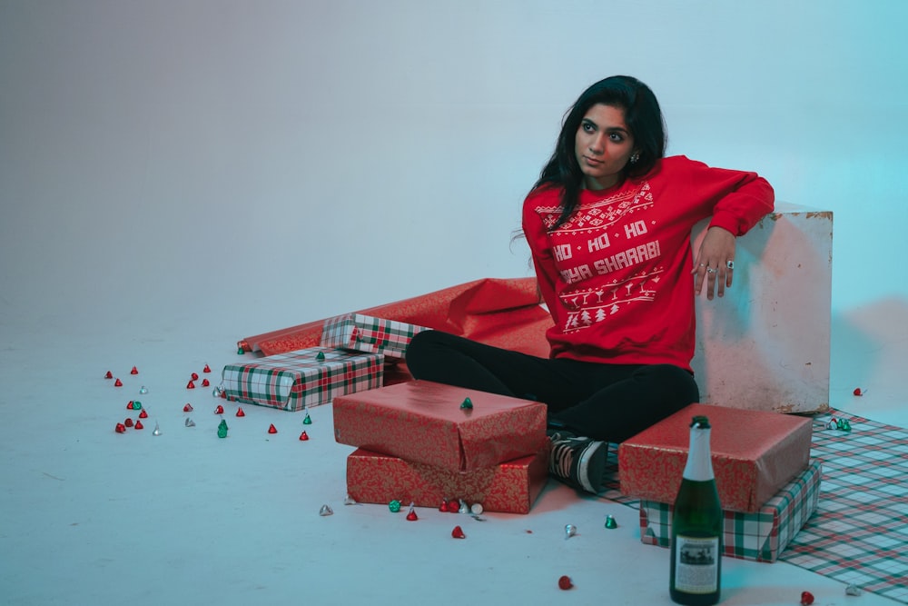 woman in pink hijab sitting on red and white plaid sofa