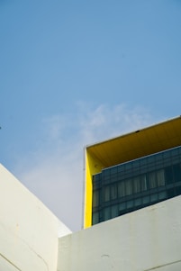 Bright and modern school building with golden yellow accents under a clear blue sky.