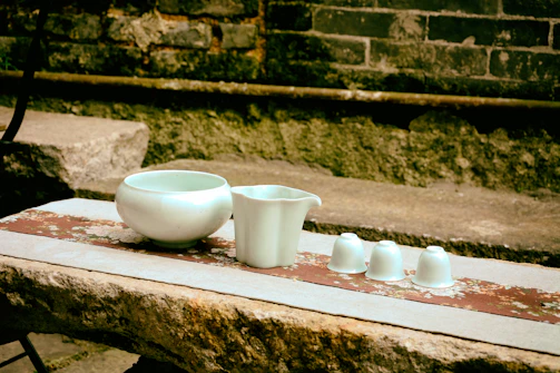 A serene kitchen scene featuring sturdy stoneware bowls and plates