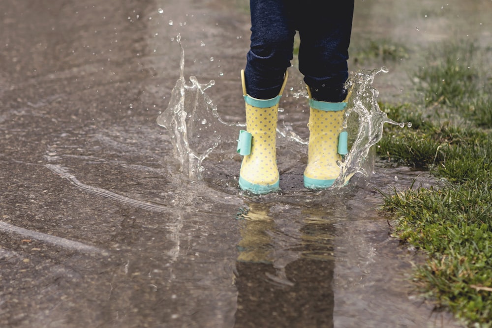 person wearing yellow rain boots