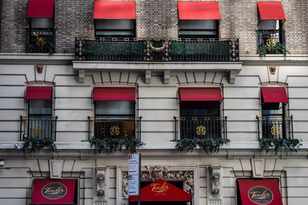 Spotted a nice building that looked pretty fancy judging by the red window shades and gold-rimmed rails, while walking the streets of New York City.