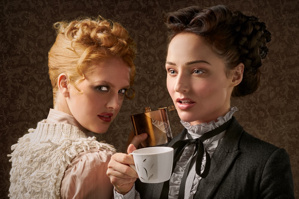 two women wearing European styled dresses