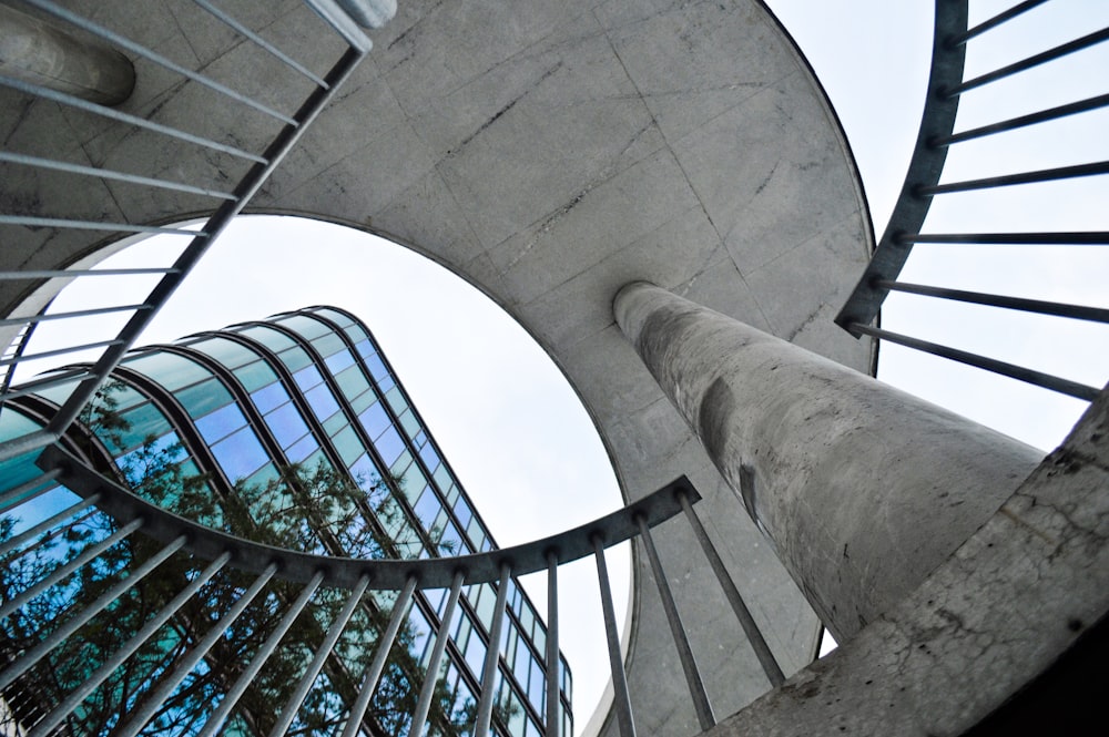 a spiral staircase in front of a tall building