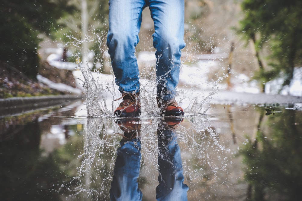 a person standing in the water with their feet in the water