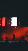 Silhouetted dancers moving freely against a backdrop of vibrant, pulsating LED visuals.