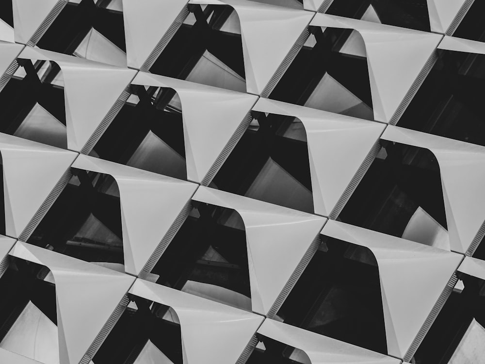 a black and white photo of a wall of mirrors