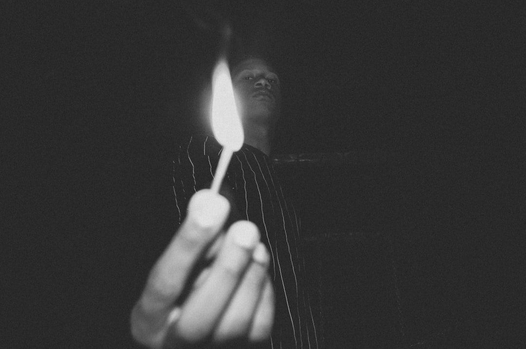 person holding burning match stick