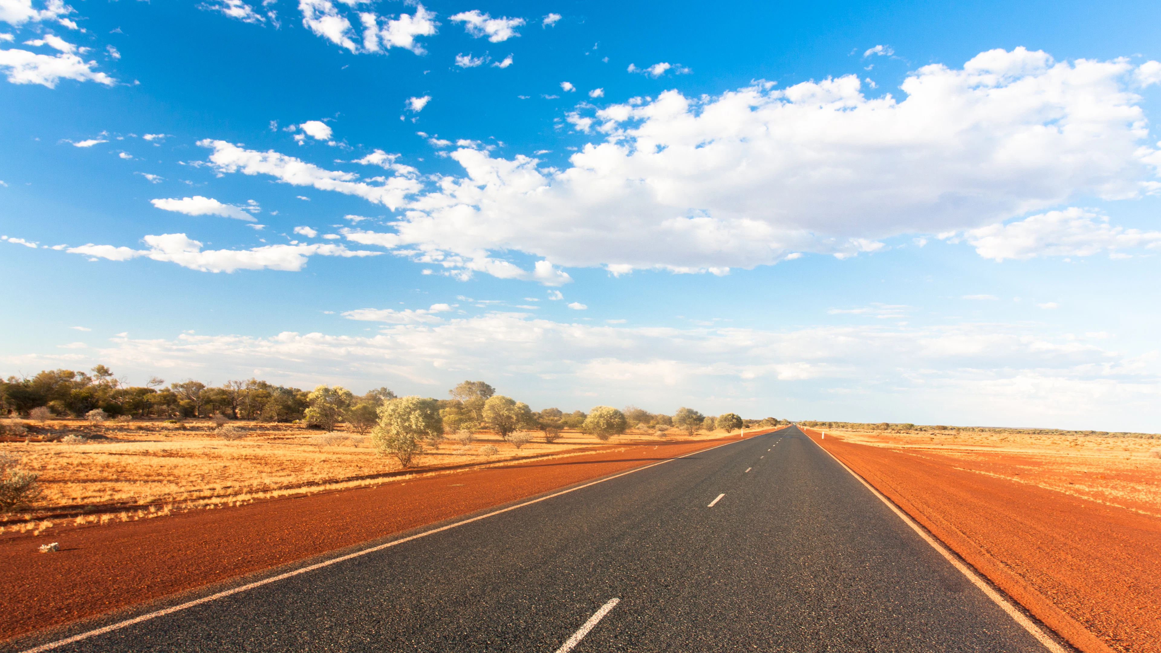 A road across red earth in Australia