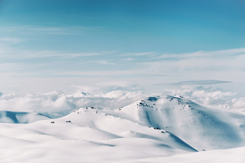 mountain covered with snow under white skies