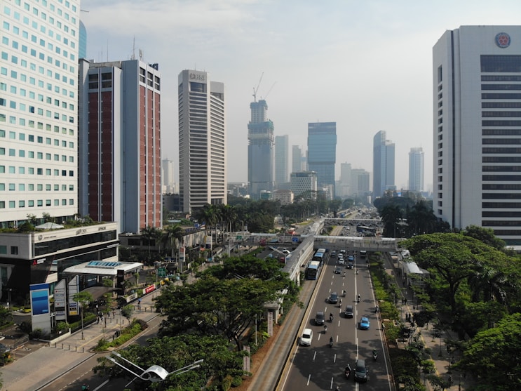 vehicles on roadway between high rise buildings
