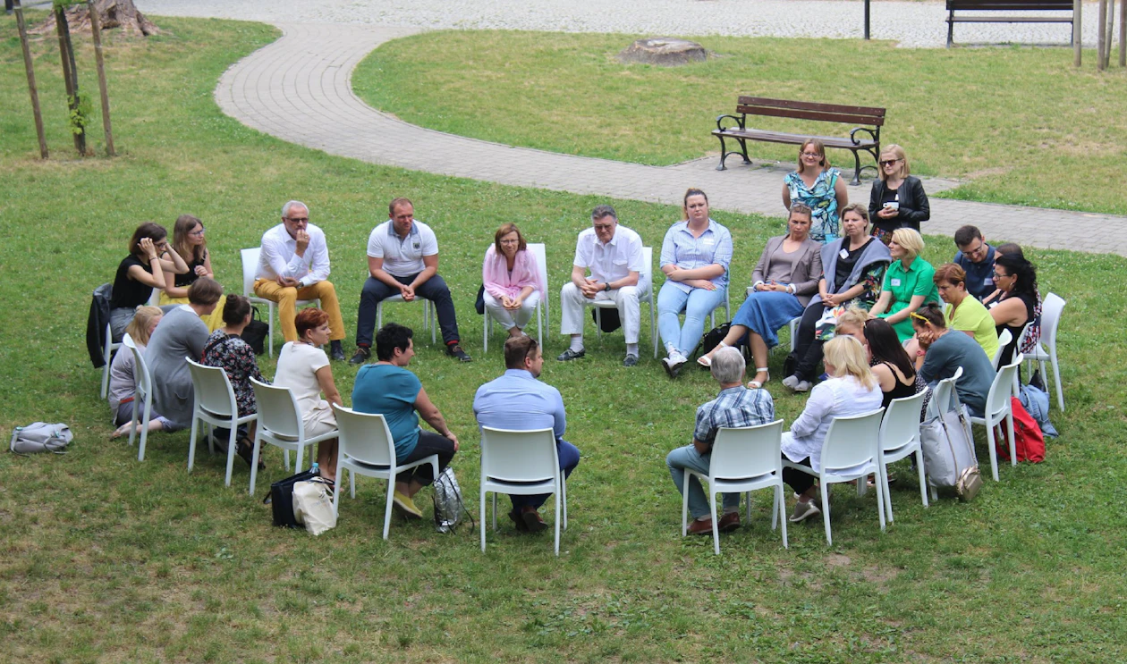 Support group sitting in a circle outdoors