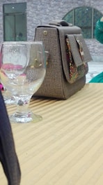 A close-up of a chic purse on a table.